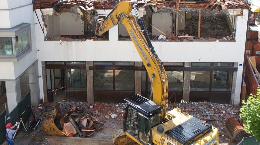 A wrecking ball at work on a home demolition project by an excavating company in southern maryland doing a job in st marys county